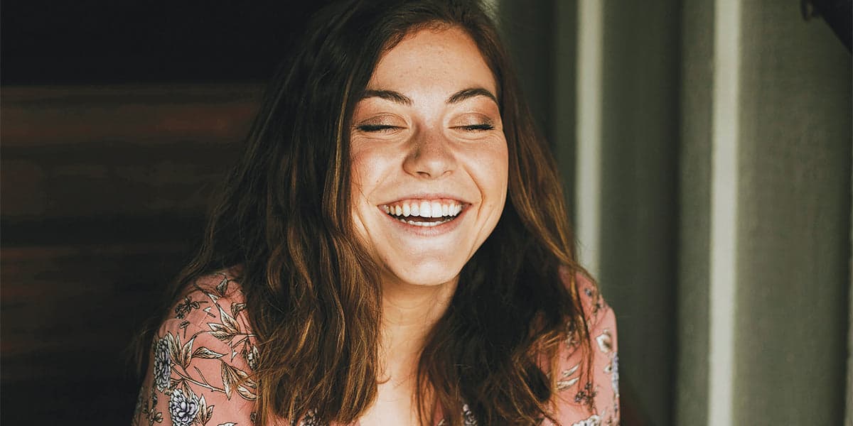 GLO Science model laughing in window light