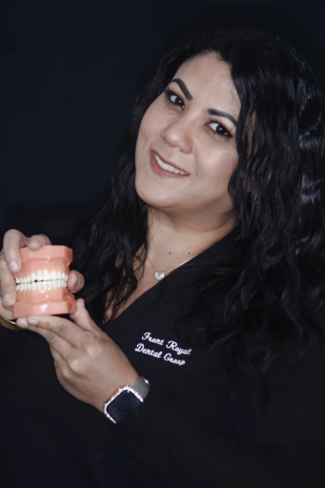 A Front Royal Dental Group assistant explaining care with a dental model